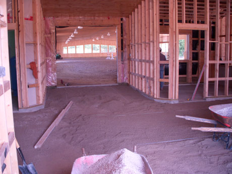 The floors usually have a concrete floor that we lay our screed pipes on for our bedding layer. This layer we compact and pull once again to avoid any settling from the horses hooves.